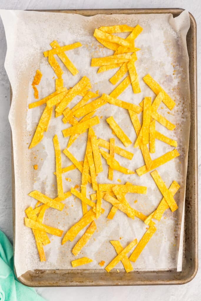 crispy tortilla strips on a baking sheet.