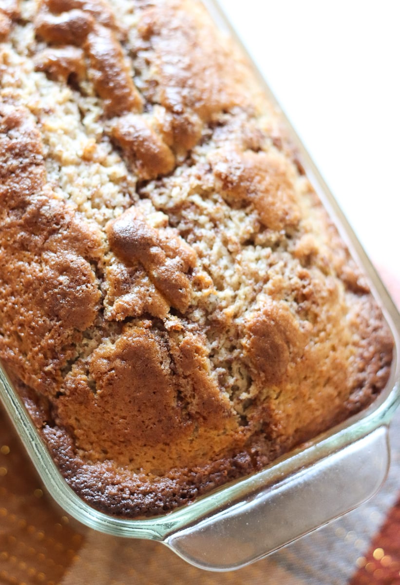loaf of cinnamon quick bread in a glass loaf pan