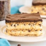 layered chocolate eclair dessert on a white plate.