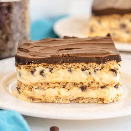 layered chocolate eclair dessert on a white plate.