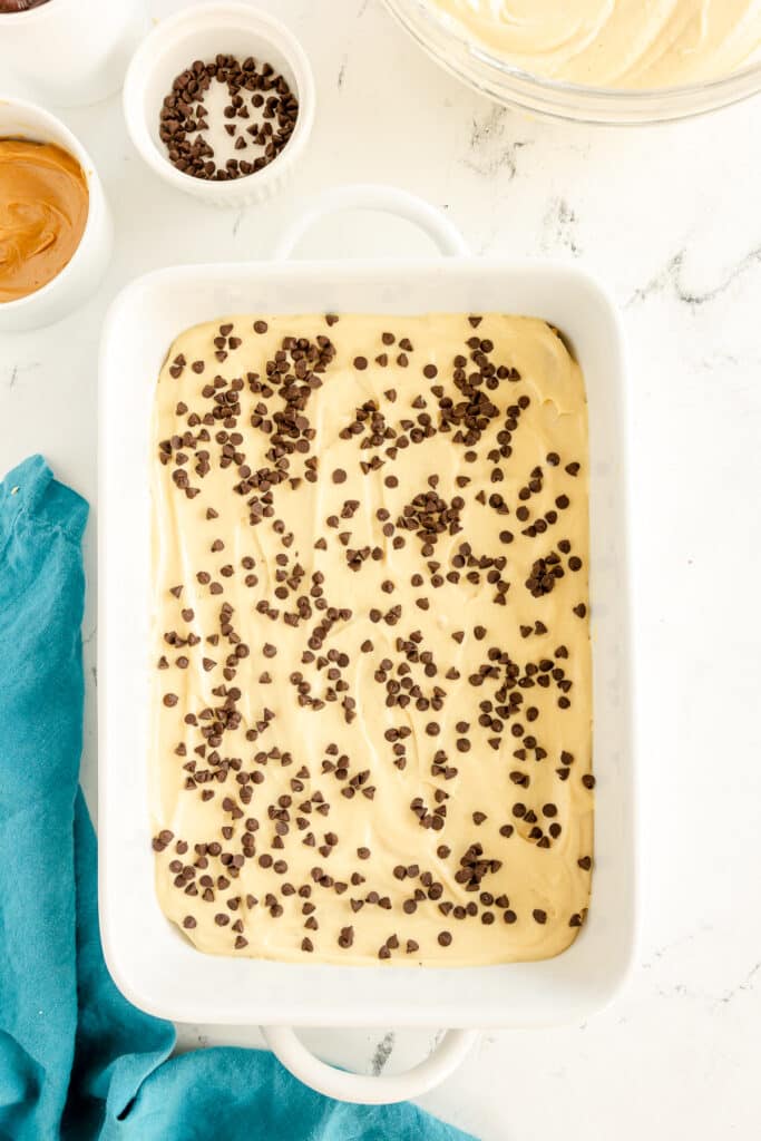 mini chocolate chips sprinkled over pudding in a baking dish.