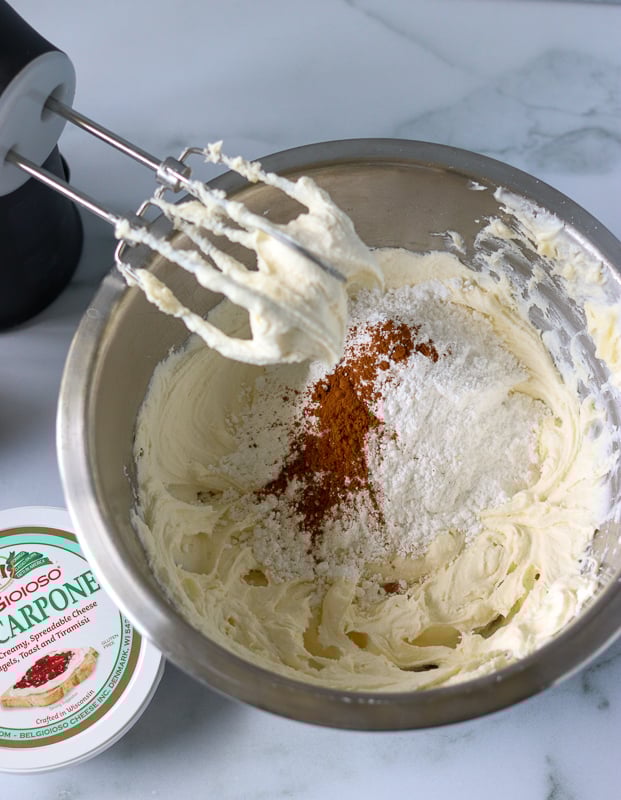 overhead shot of frosting in mixing bowl with hand mixer