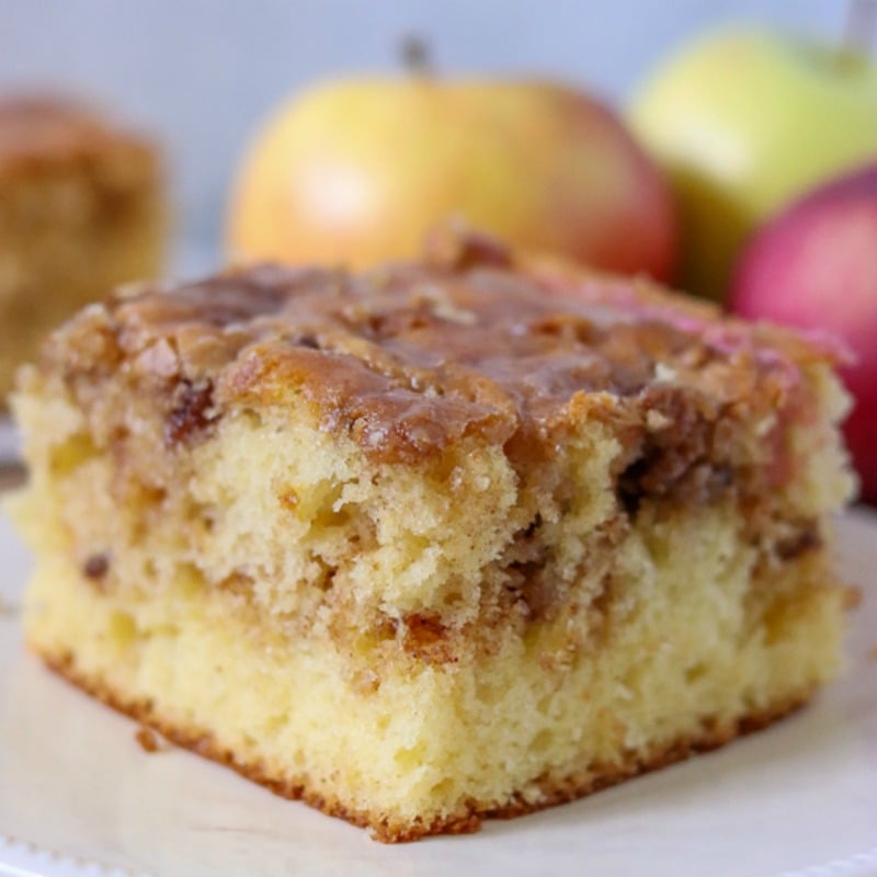 close up of slice of honey bun cake on white plate