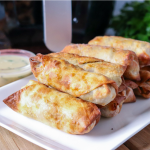 white plate with stack of turkey & stuffing air fryer egg rolls