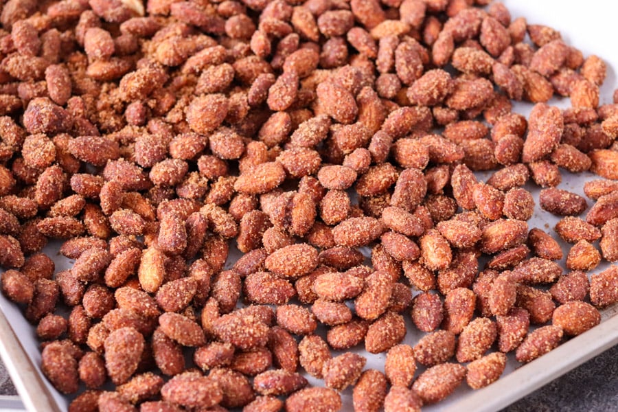 candied almonds spread out on baking sheet