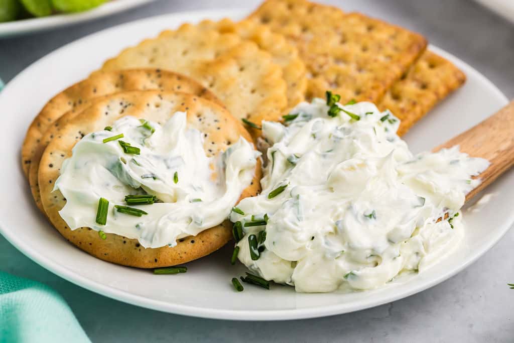 garlic herb dip spread on a cracker.