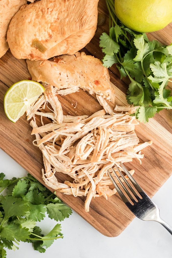 shredded chicken breast on a cutting board