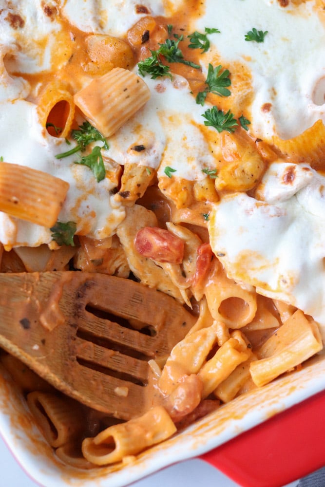 overhead shot of cheesy pasta with serving spoon