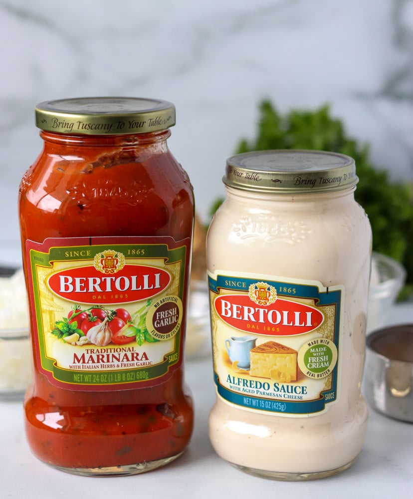 two jars of bertolli marinara and alfredo sauce