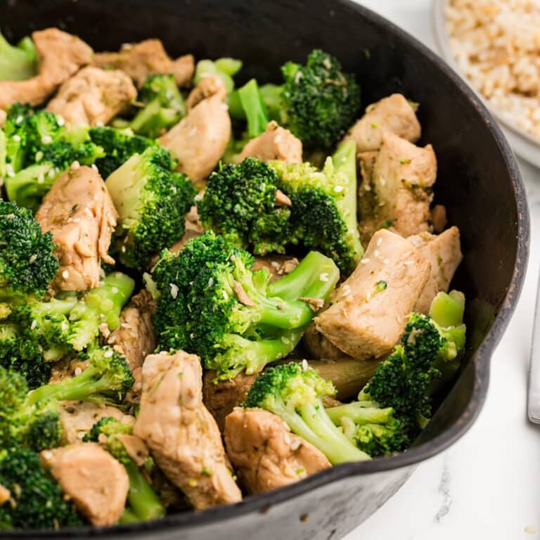 closeup of chicken & broccoli in a cast iron skillet.