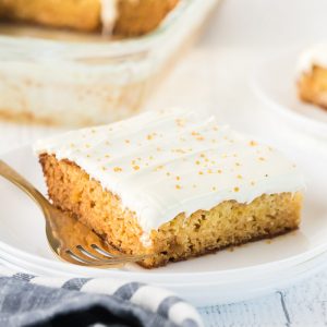 slice of mexican wedding cake on a white plate with a fork
