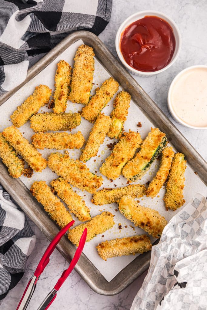 overhead shot of zucchini fries on a baking sheet.