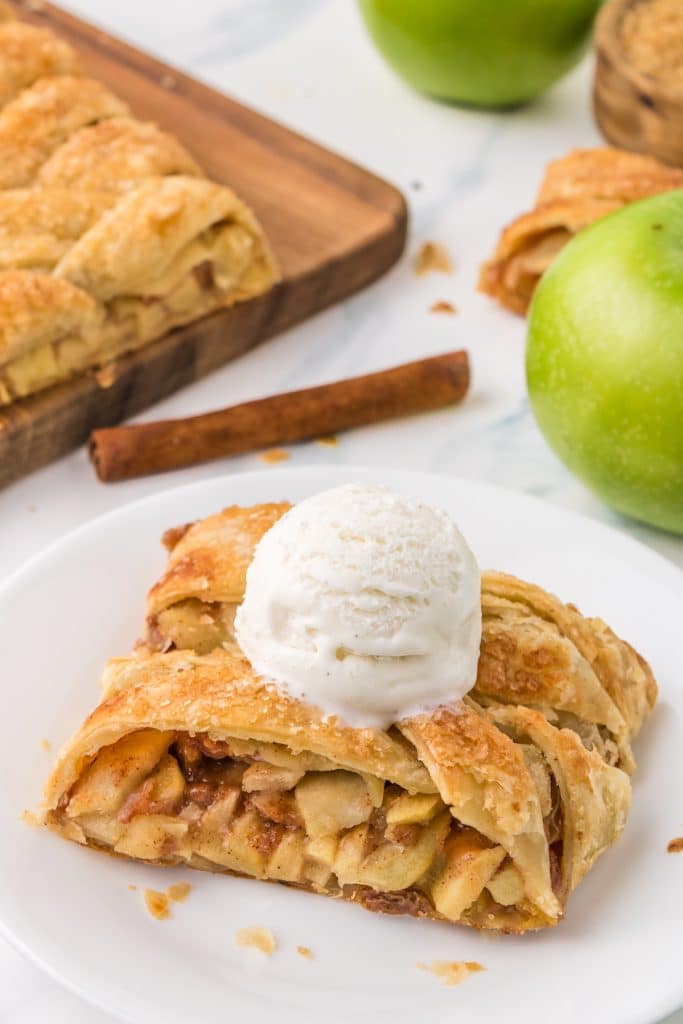 slice of apple strudel topped with vanilla ice cream.