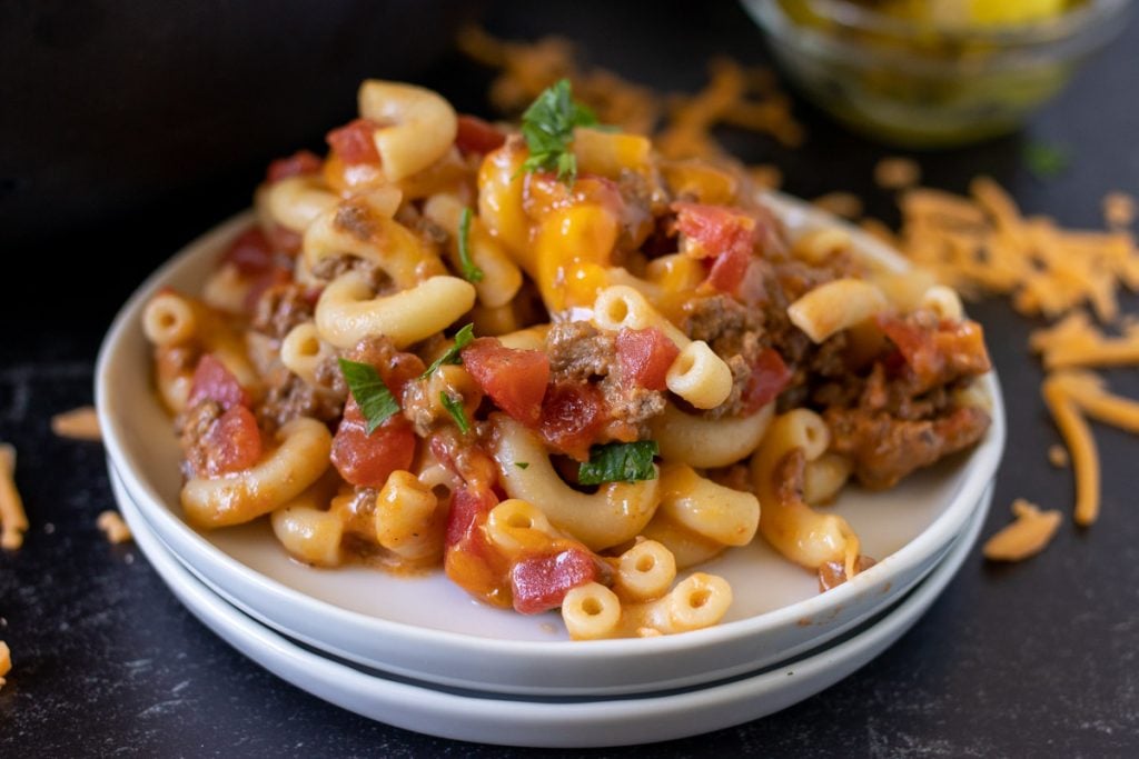 close up of cheeseburger noodle casserole on white plates