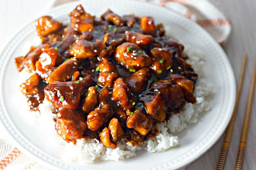 large plate of bourbon chicken over white rice