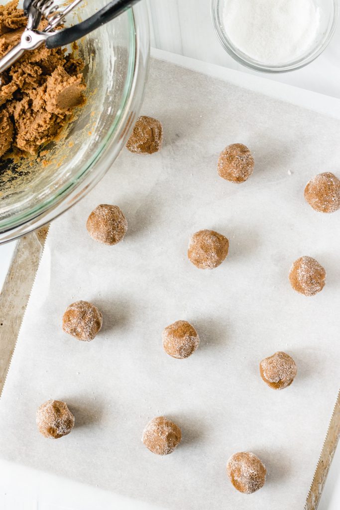 cookie dough balls on a baking sheet