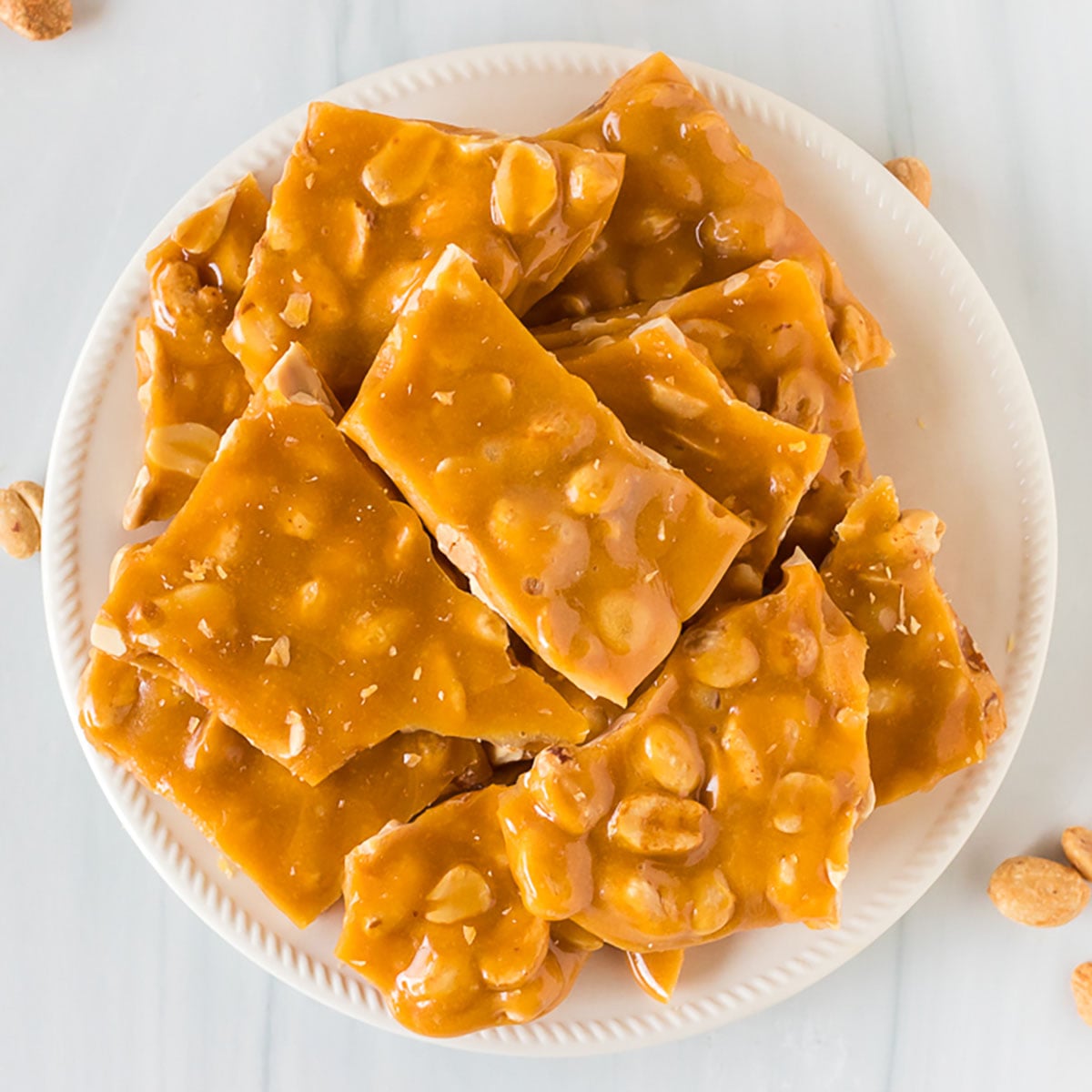 stack of peanut brittle on a white plate
