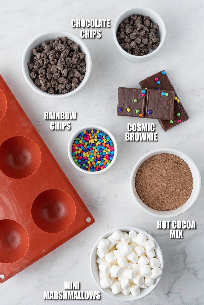 overhead shot of silicone mold and ingredients laid out to make hot cocoa bombs