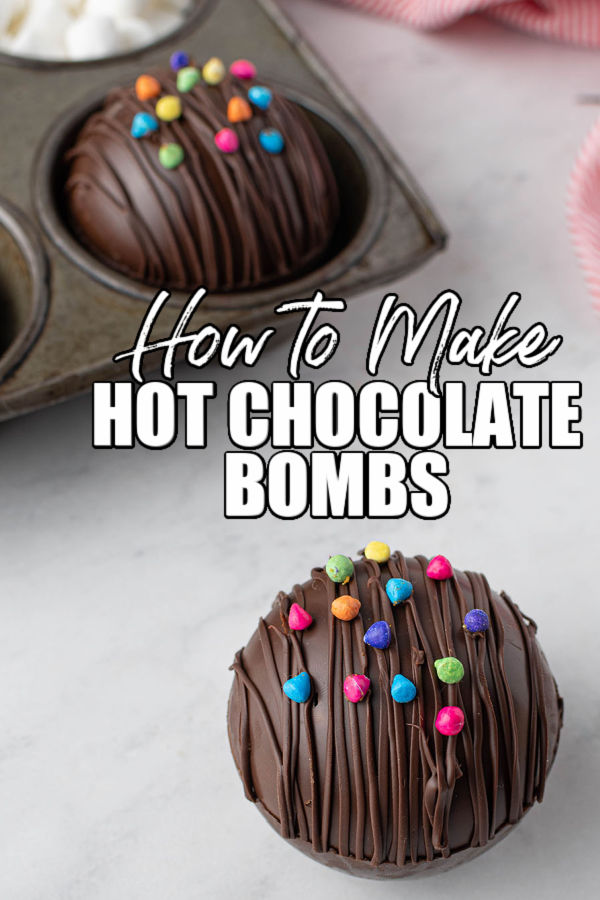 hot cocoa bomb topped with rainbow chips with text reading "how to make hot chocolate bombs"