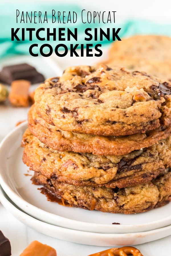 stack cookies on a white plate with text overlay reading "panera copycat kitchen sink cookies"
