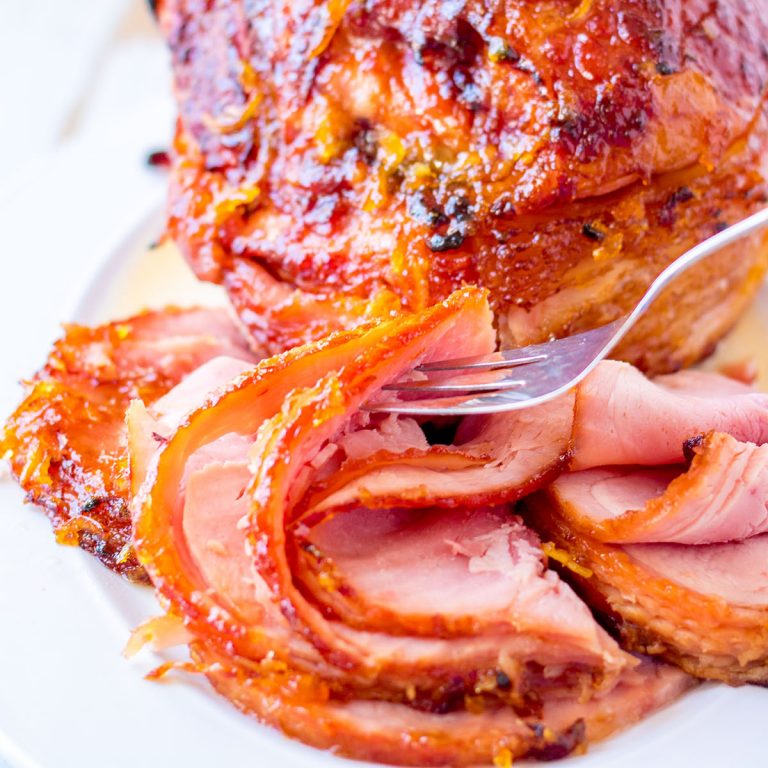 fork picking up a slice of spiral sliced ham