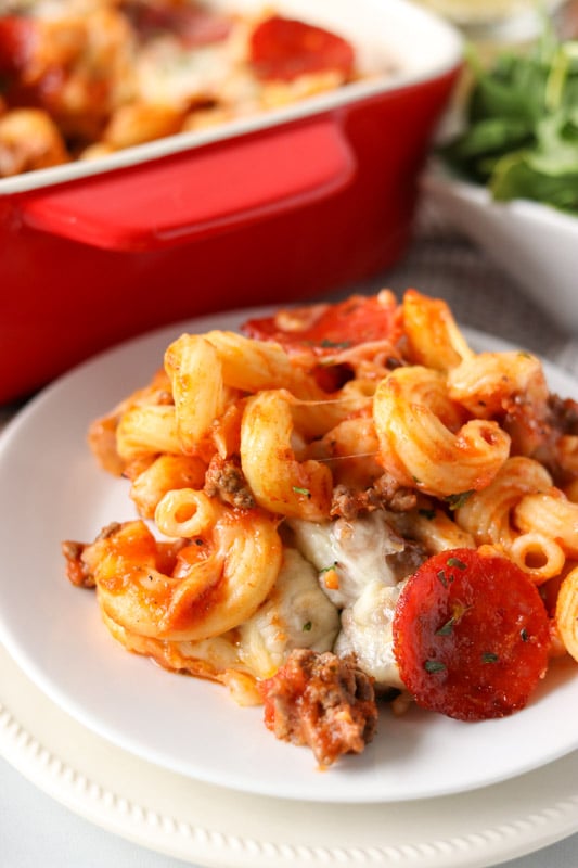 white plate topped with pasta and pepperoni