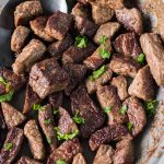 close up of garlic steak bites topped with parsley
