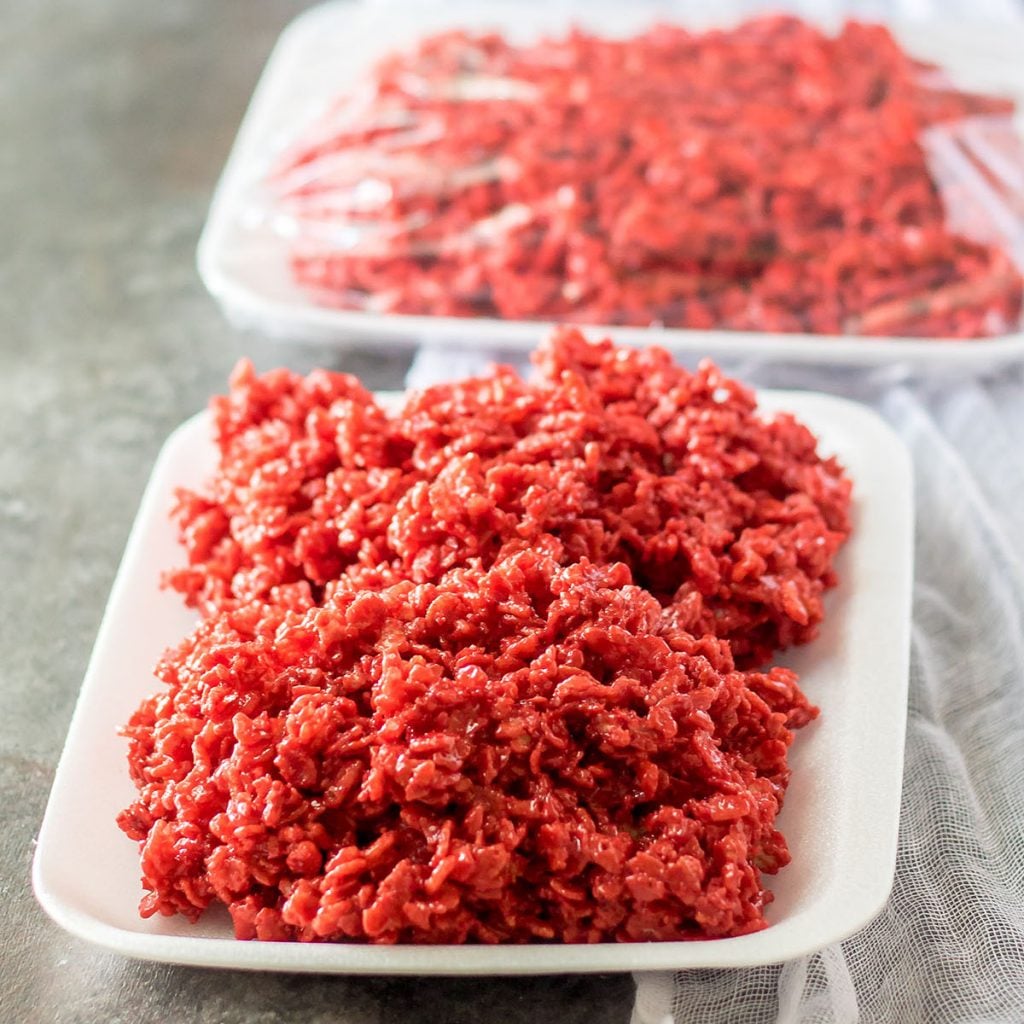 red velvet rice krispies on a white tray that look like raw meat