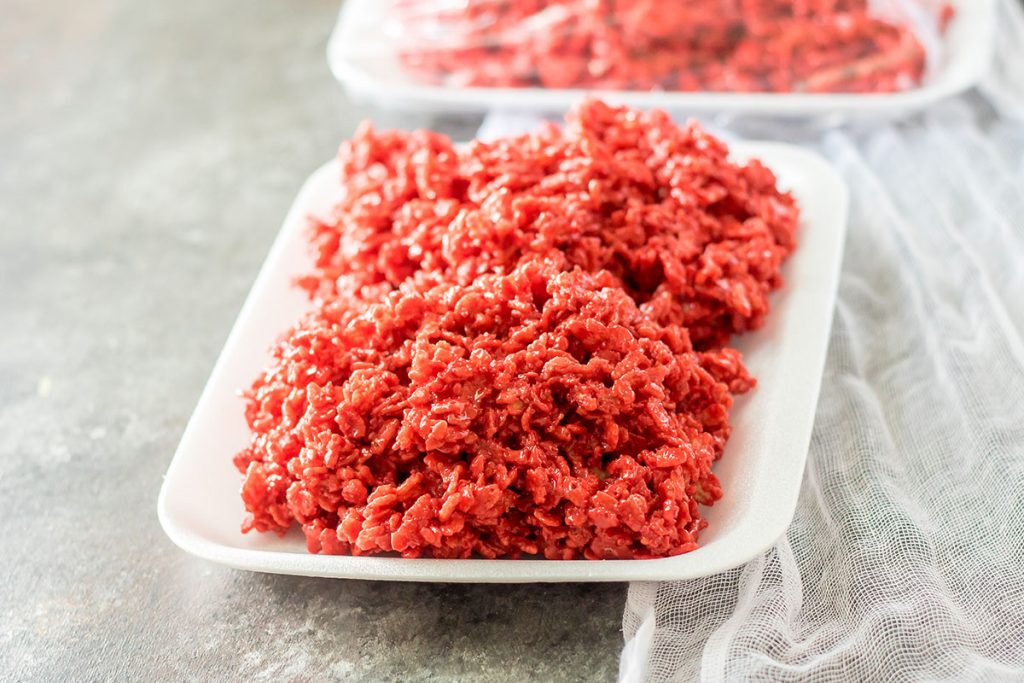 red rice krispies on a white foam tray that looks like raw meat