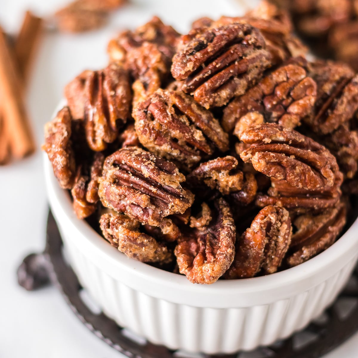 closeup shot of candied pecans in a white bowl