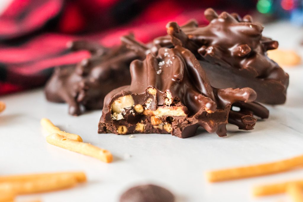 closeup of a haystack cookie with a bit missing showing the chow mein noodles and cashews