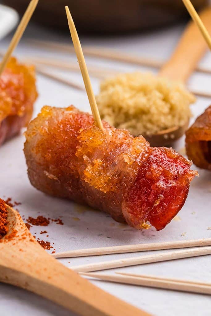 closeup of a bacon wrapped little smokie.