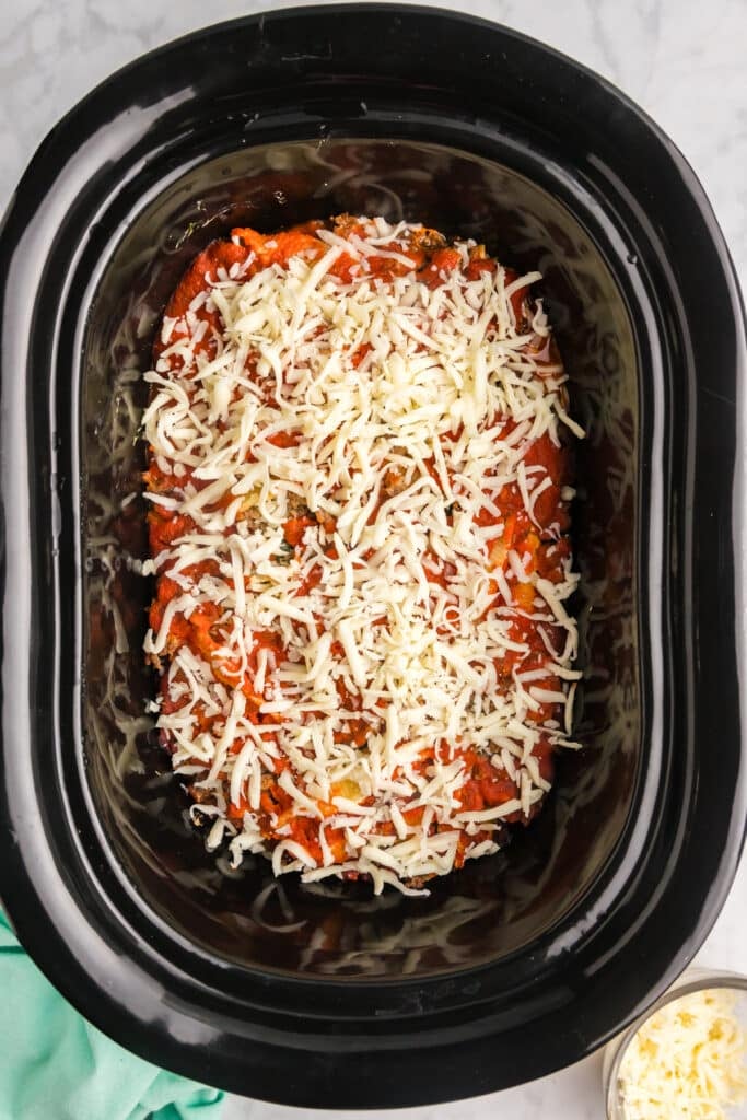 overhead shot of sauce & cheese in crockpot.