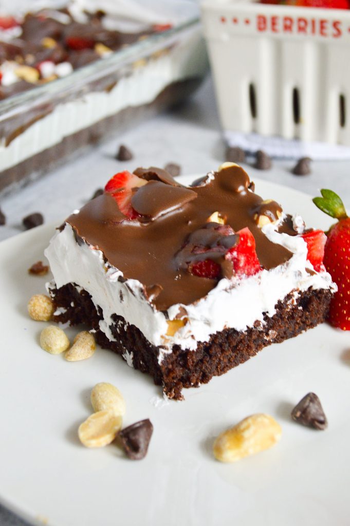 plate of layered brownie delight dessert topped with chocolate.
