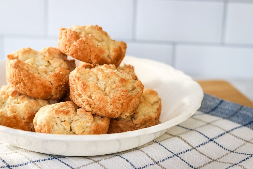 white bowl of biscuits on a checkered towel.