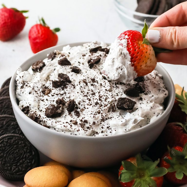 strawberry dipping into oreo dip.