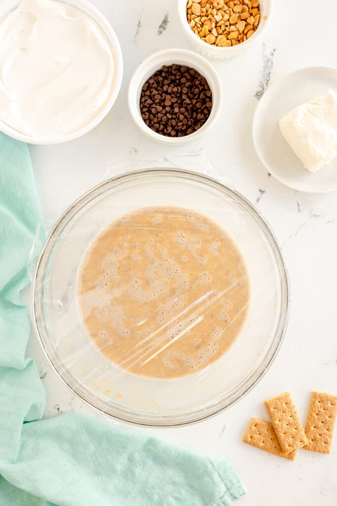 mixing bowl covered with plastic wrap.