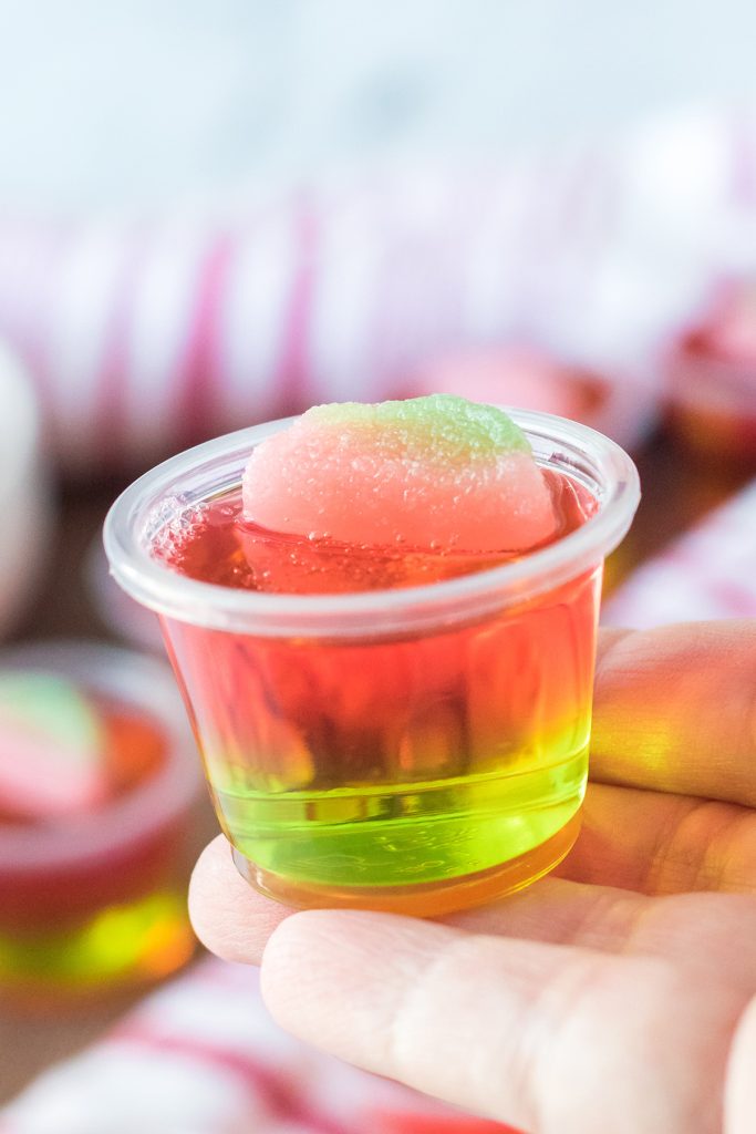 hand holding a 1 ounce jello shot.