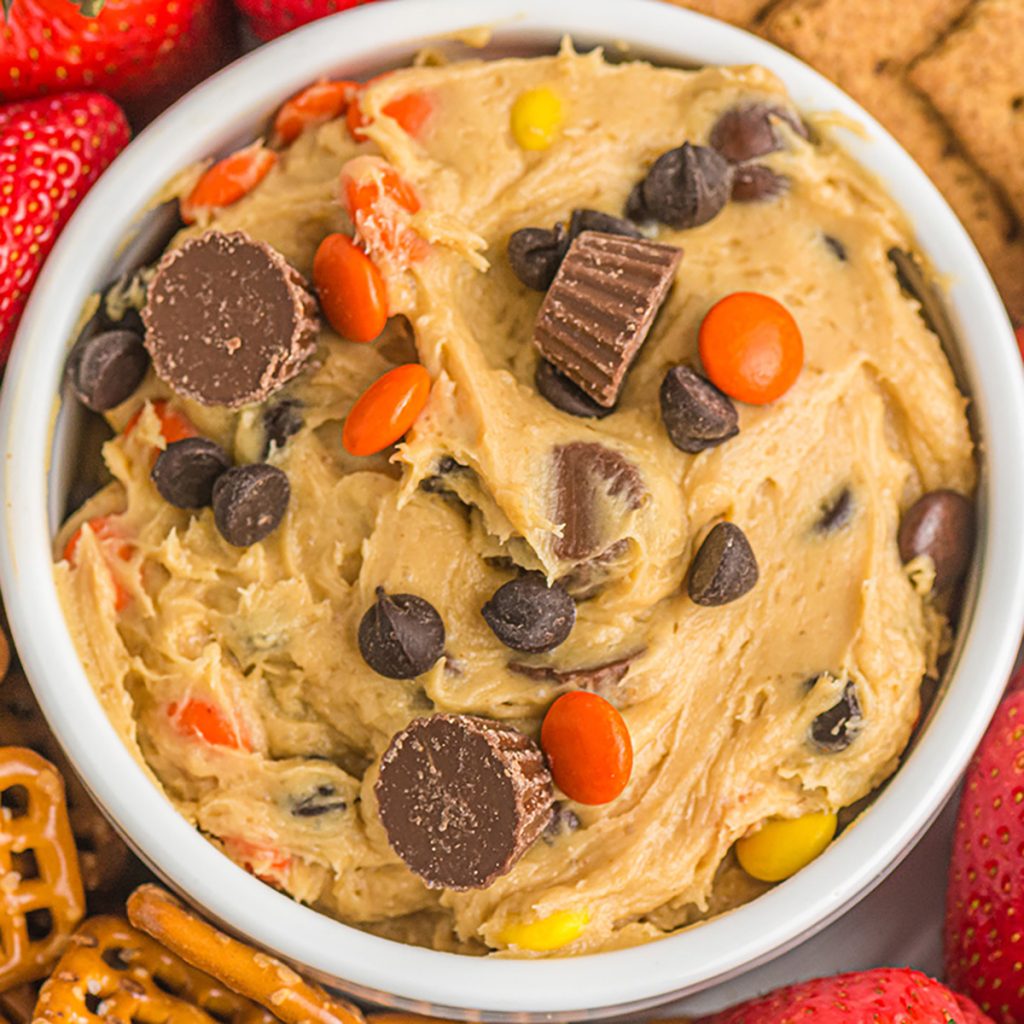closeup overhead shot of peanut butter cup cookie dough dip topped with mini peanut butter cups.