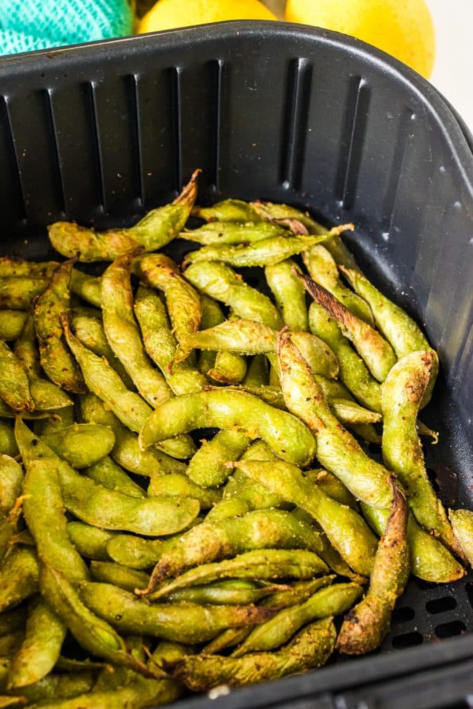 roasted edamame in an air fryer basket.