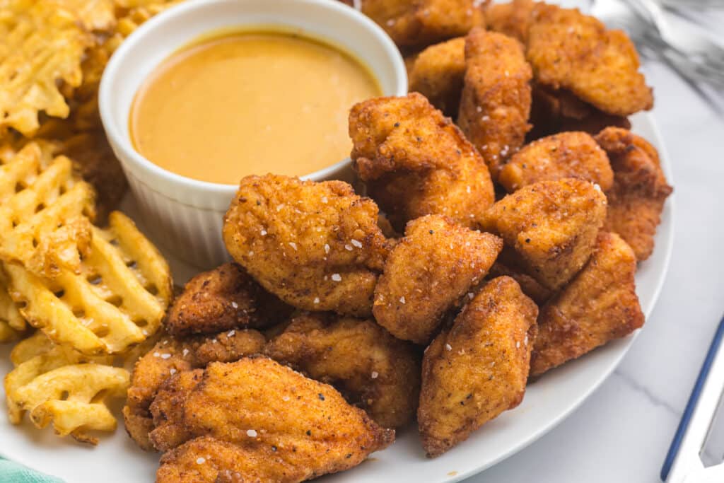 Chicken nuggets served with honey mustard and waffle fries.
