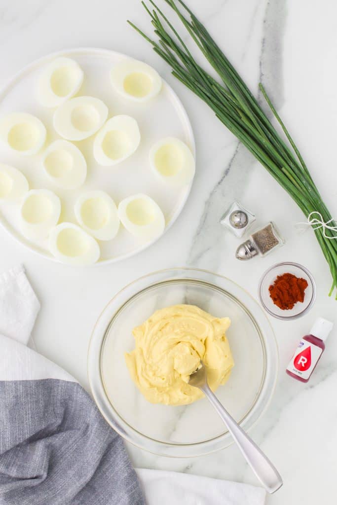 overhead shot of deviled egg filling in a mixing bowl.