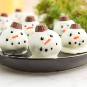 plate of oreo balls decorated as snowmen.