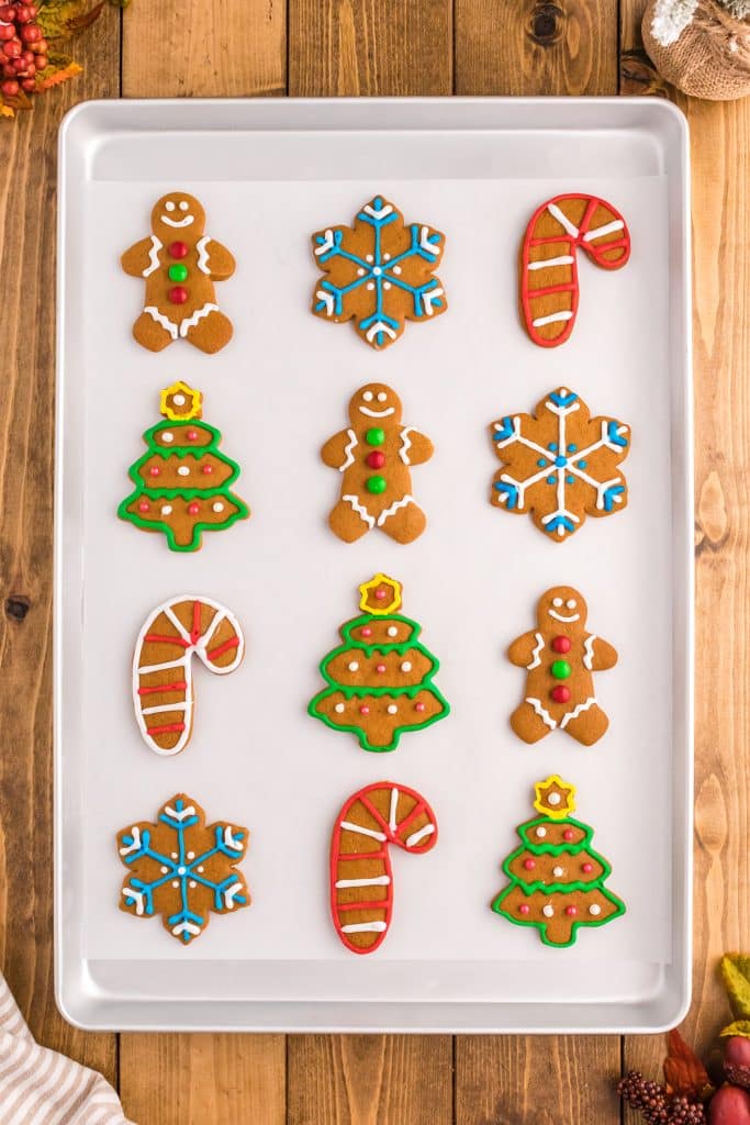 overhead shot of gingerbread cookies on a cookie sheet.