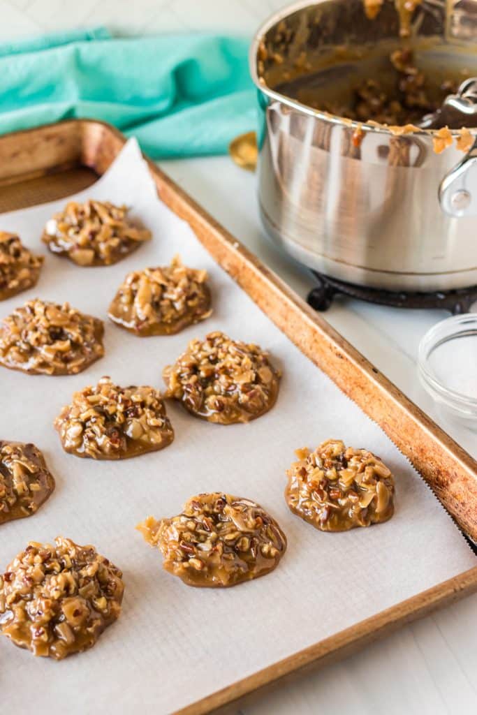 baking sheet full of cookies next to a saucepan.