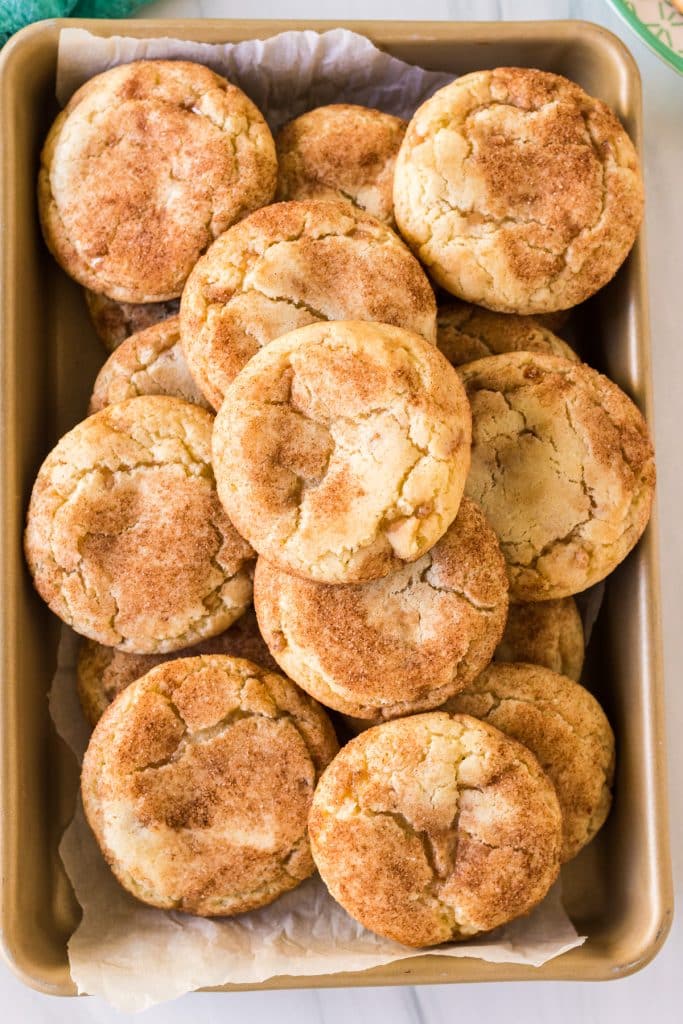 overhead shot of toffeedoodle cookies piled on a baking sheet.