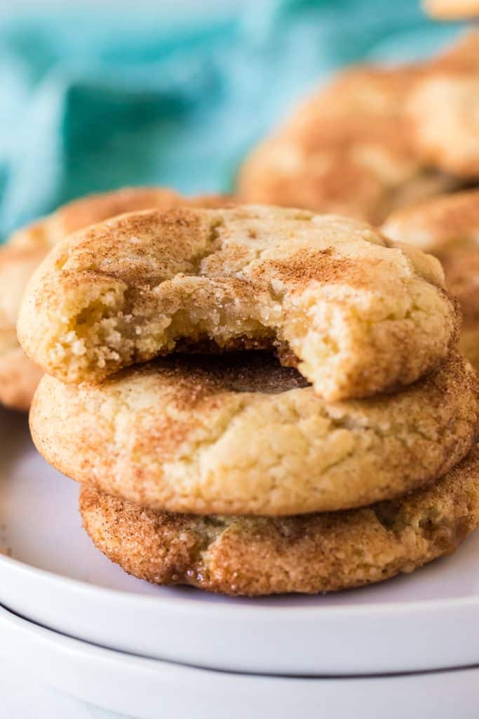 stack of toffee doodle cookies with a bite missing from the top.