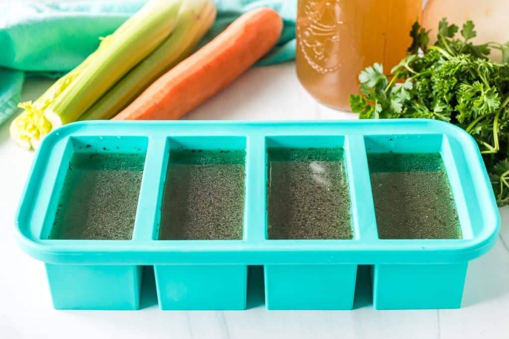 chicken stock in souper cubes freezer container.