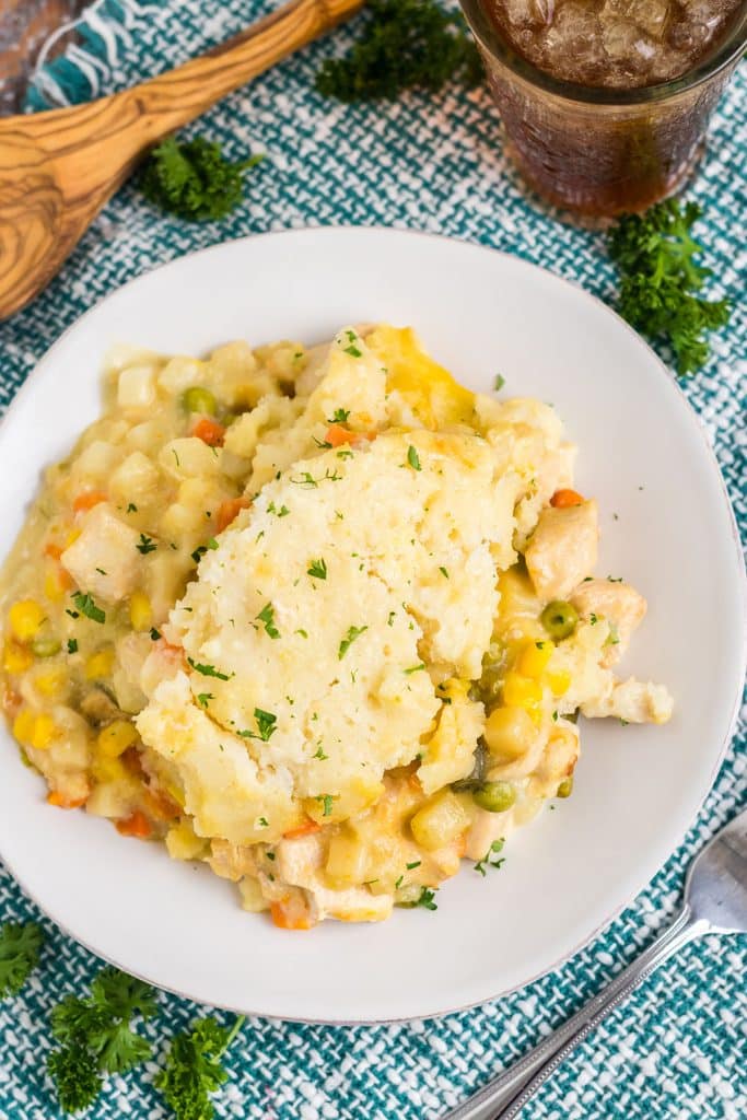 plate of chicken cobbler with a glass of tea.