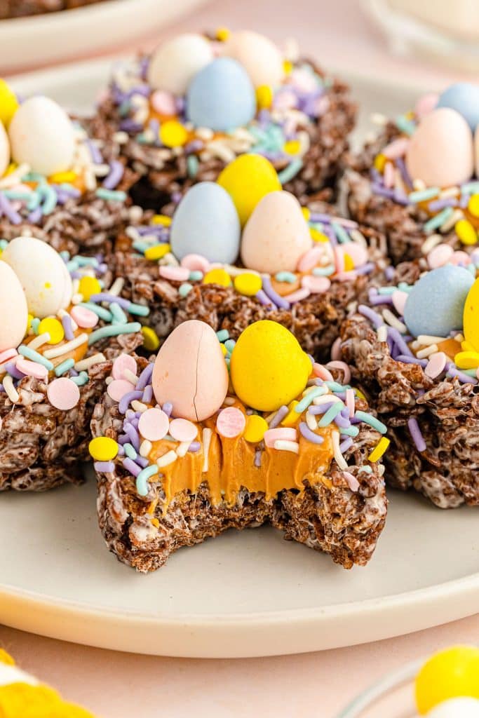 bird nest cookie with a bite missing showing the peanut butter filling.